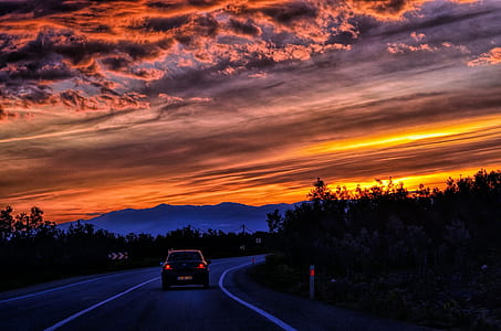 car cruising on asphalt road during sunset thumbnail