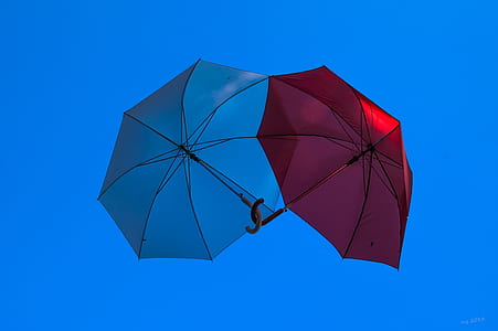 two blue and red umbrellas thumbnail