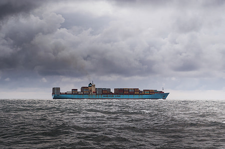 photo of blue cargo ship in body of water during daytime thumbnail