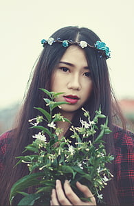 woman holding plant thumbnail