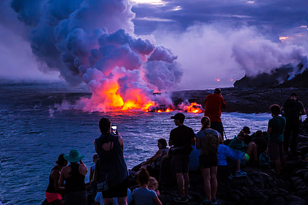 photo of people near the body of water and fire thumbnail