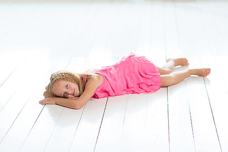 braided blonde girl wearing pink dress lying on floor thumbnail