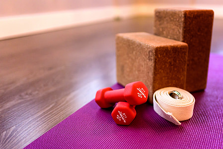 two red dumbbells on purple yoga mat thumbnail