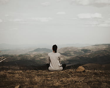 woman siting on grass field thumbnail