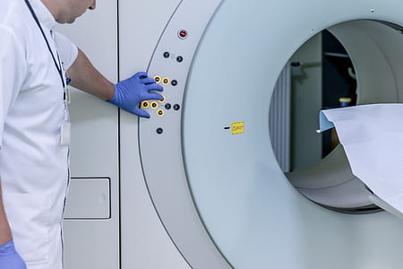 photo of person standing behind MRI scan thumbnail