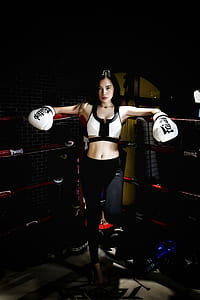woman wearing boxing gloves leaning against ring corner thumbnail