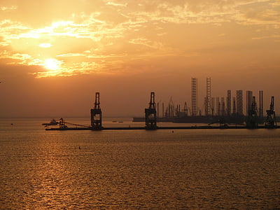 building near sea during sunset thumbnail