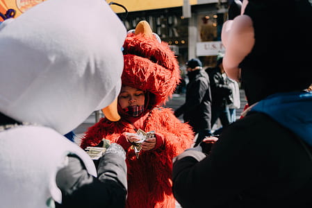person in Elmo costume counting money thumbnail