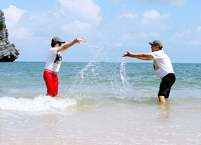 Man And Woman Splashing Water To Each Other thumbnail