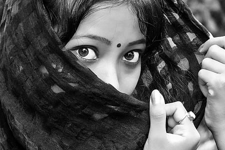 woman face holding black textile thumbnail