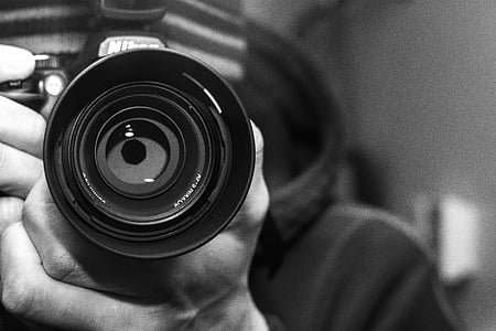 person holding DSLR camera thumbnail