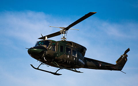 black and brown helicopter flying under blue sky thumbnail