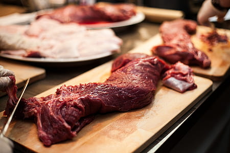 raw meat on brown wooden chopping board thumbnail