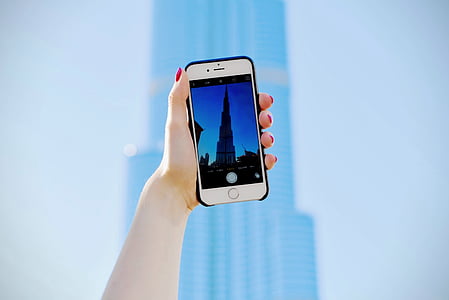 person taking a photo of Burj Khalifa building in Dubai during daytime thumbnail