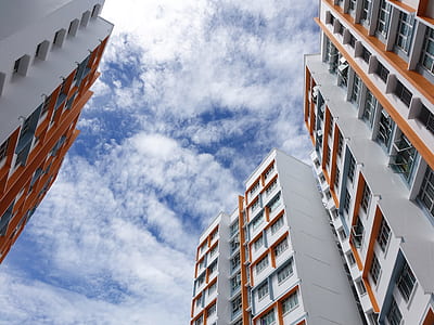 four gray-and-orange concrete buildings under blue s kyh thumbnail