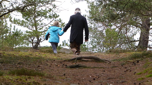 child and man walking on forest trail thumbnail