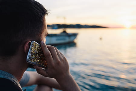 Mobile phone in man's hands near the sea thumbnail