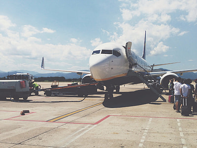 white airliner at the port with luggages thumbnail