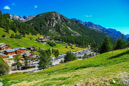 aerial photography of mountain and houses at daytime thumbnail