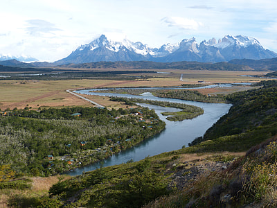 body of water surrounded by tree against mountain hill thumbnail