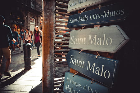 several Saint Malo wooden signages hanged on beige wooden stall thumbnail