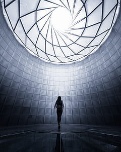 woman in black dress under skylight indoors thumbnail