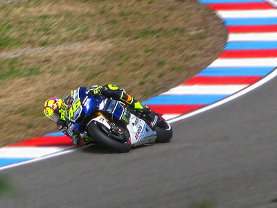 person riding sports bike on track during daytime thumbnail