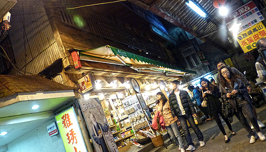 people standing between stalls during night thumbnail