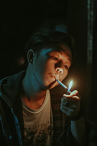 man lighting cigarette thumbnail