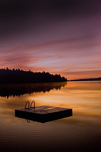 square wooden dock on body of water thumbnail