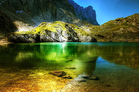 lake beside the mountain during daytime thumbnail