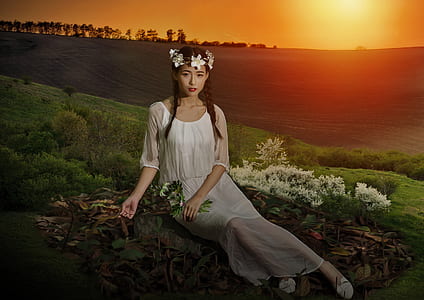woman sitting on grass field thumbnail