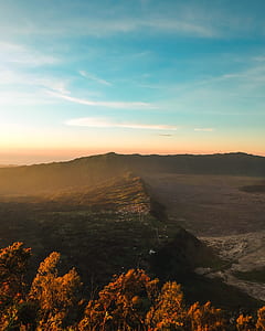 brown mountains under blue sky thumbnail