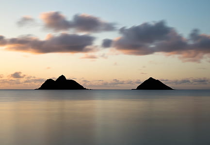photography of body of water near two mountains thumbnail