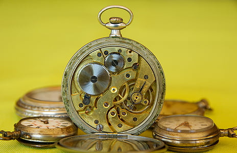 selective photography of round gold-colored and white pocket watch thumbnail
