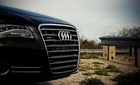 close-up photo of black Audi vehicle parked near railings thumbnail