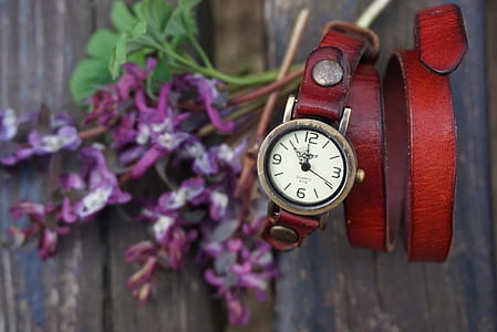 round gold-colored analog watch with red leather strap thumbnail