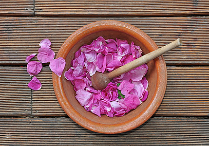 flat lay photography of pink petals in brown pot thumbnail