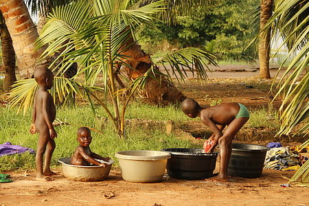 kids bathing near trees during daytime thumbnail