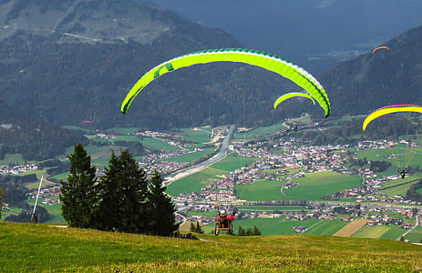 man doing paragliding during daytime thumbnail