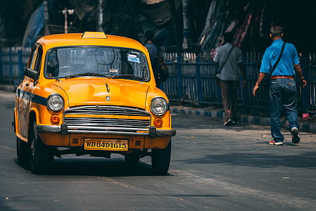 yellow taxi cab on grey asphalt road during daytime thumbnail