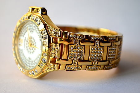 round gold-colored analog watch with gold-colored link bracelet thumbnail