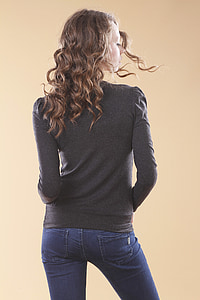 woman wearing black crew-neck long-sleeved top and blue jeans thumbnail