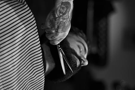 grayscale photo of man trimming beard thumbnail