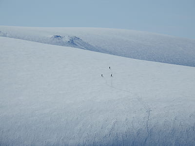 three people trailing each other on snow mountain thumbnail