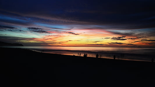 group of people watching sunset on beach thumbnail