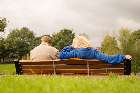 man and woman sitting on bench during daytime thumbnail