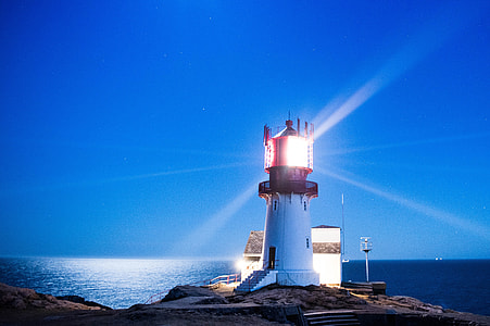 low light photography of a white lighthouse thumbnail