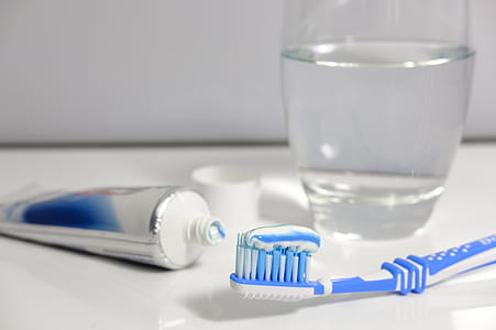 blue and white toothbrush beside white and blue toothpaste soft-tube thumbnail