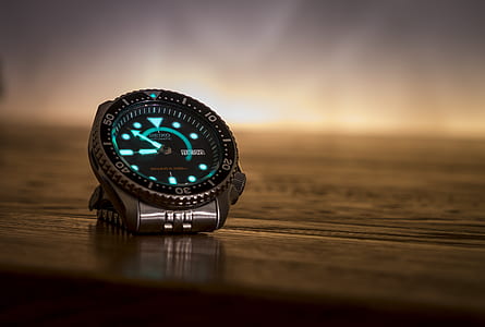 analog watch on brown wooden surface thumbnail